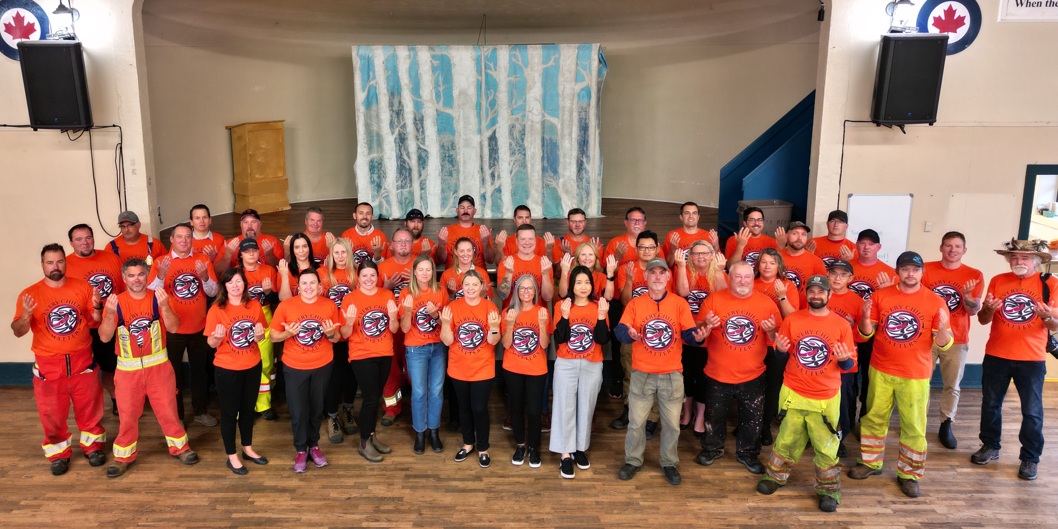 Orange Shirts raised hands